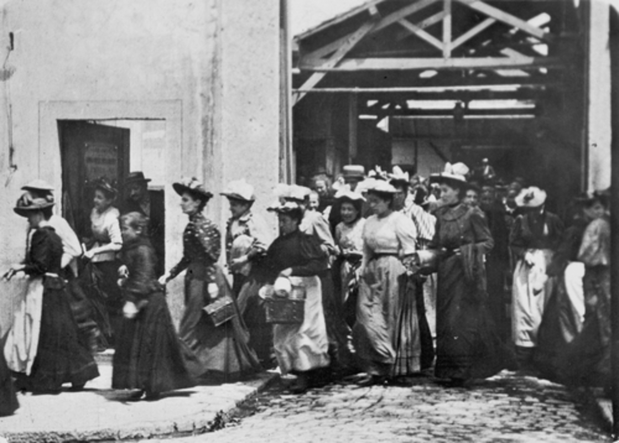 Black and white image of women workers leaving the Lumière Factory